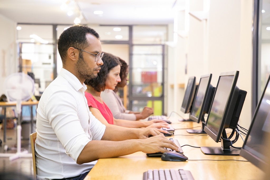 Diverse group of students taking online tests