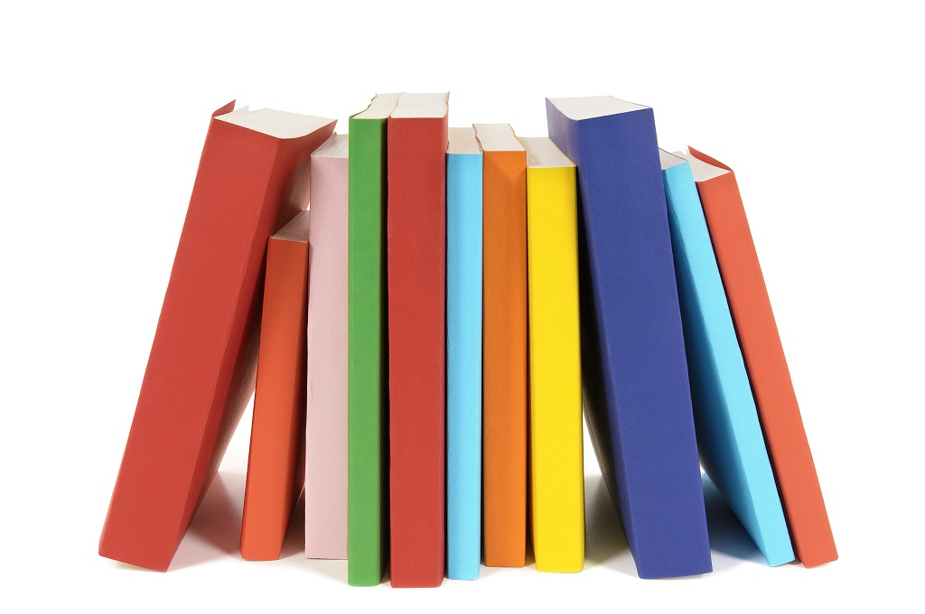 Small row of books isolated on white background .